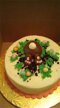 This little bunny is diving in to get a bite of this delicious Easter cake.
