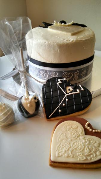 The bride chose bride & groom cookies and cake pops for the guests.  Cake was a small 6" round trimmed in wedding colors.