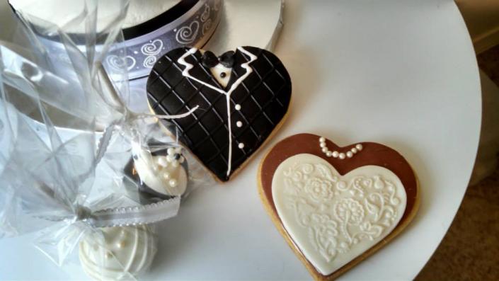 Heart shaped tuxedo & bridal gown cookies are a perfect complement to the wedding cake.